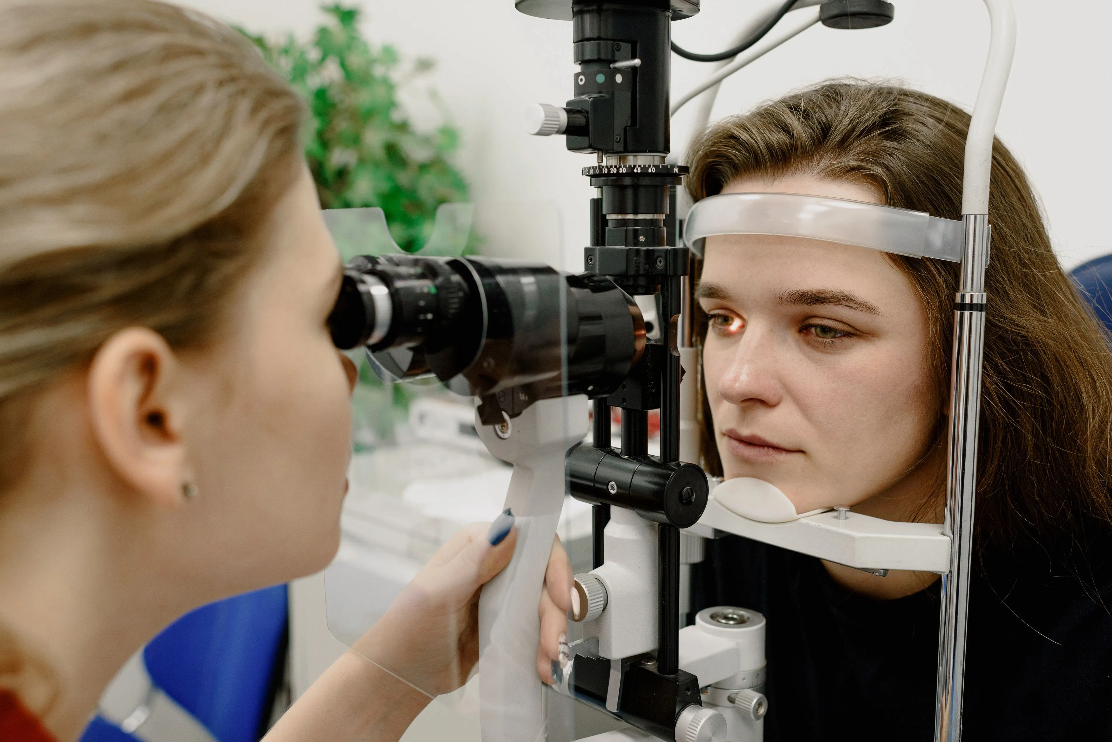 An optometrist examines the eye of a patient.