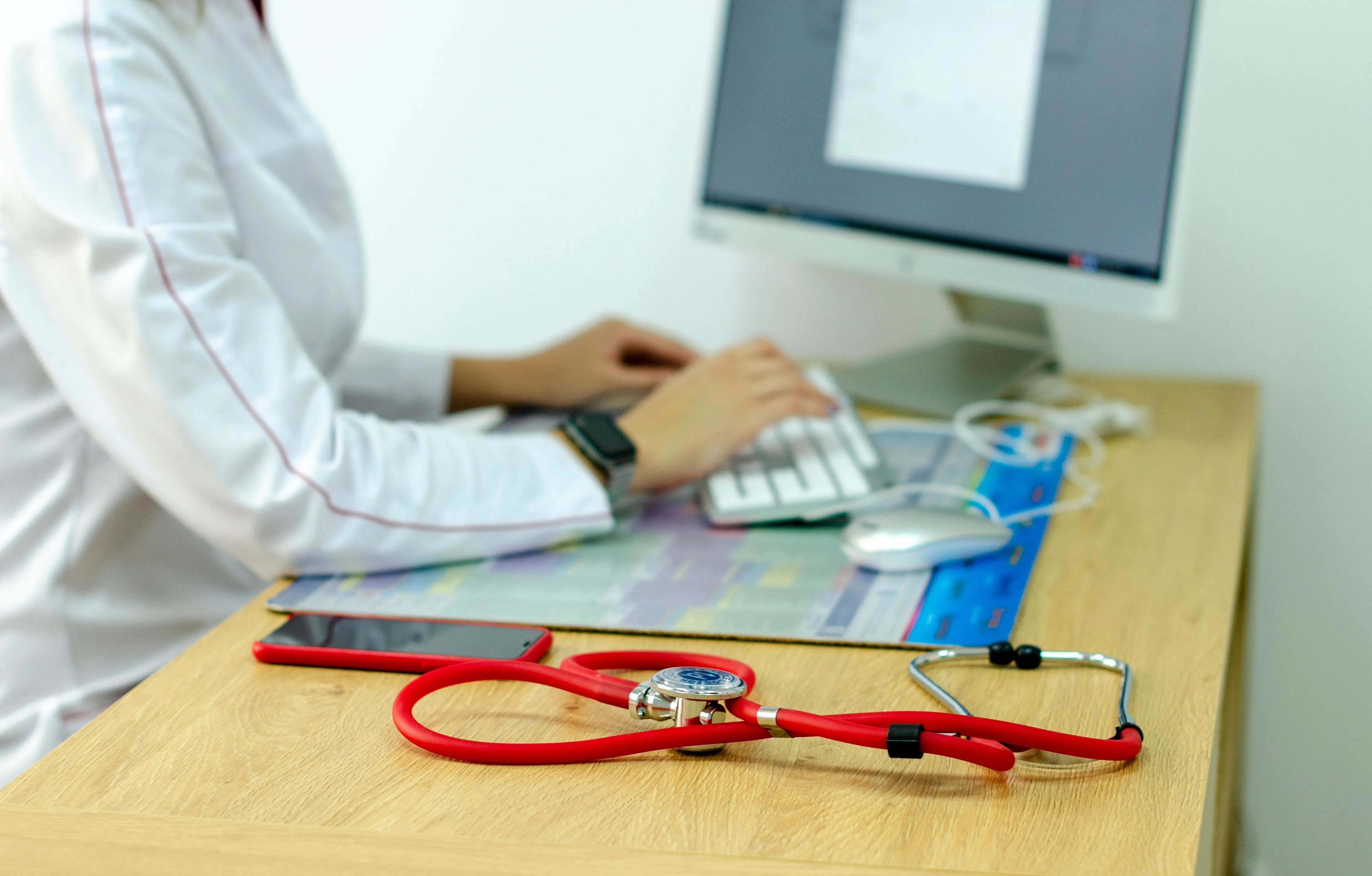 Doctor typing at computer