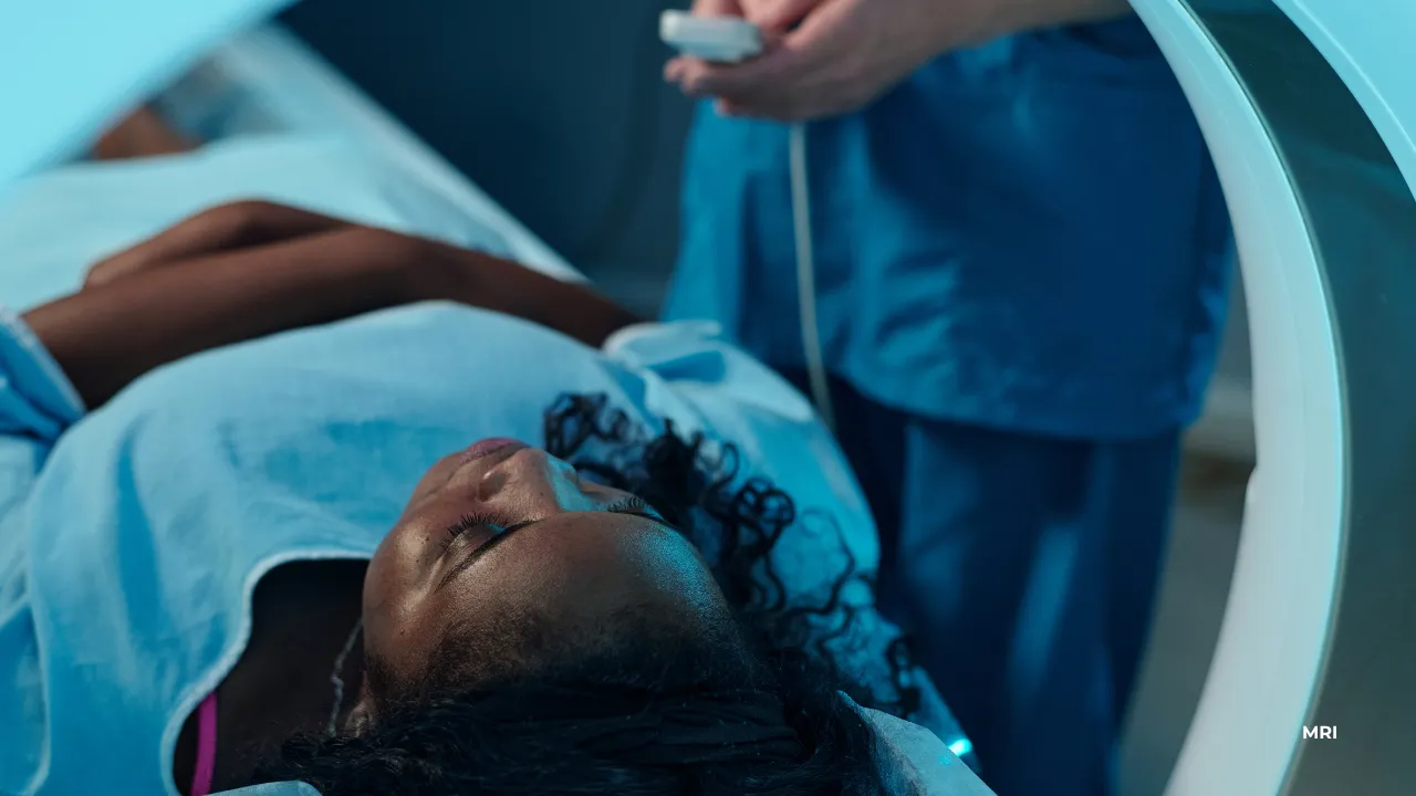 A person lays on a flat surface ready for an MRI