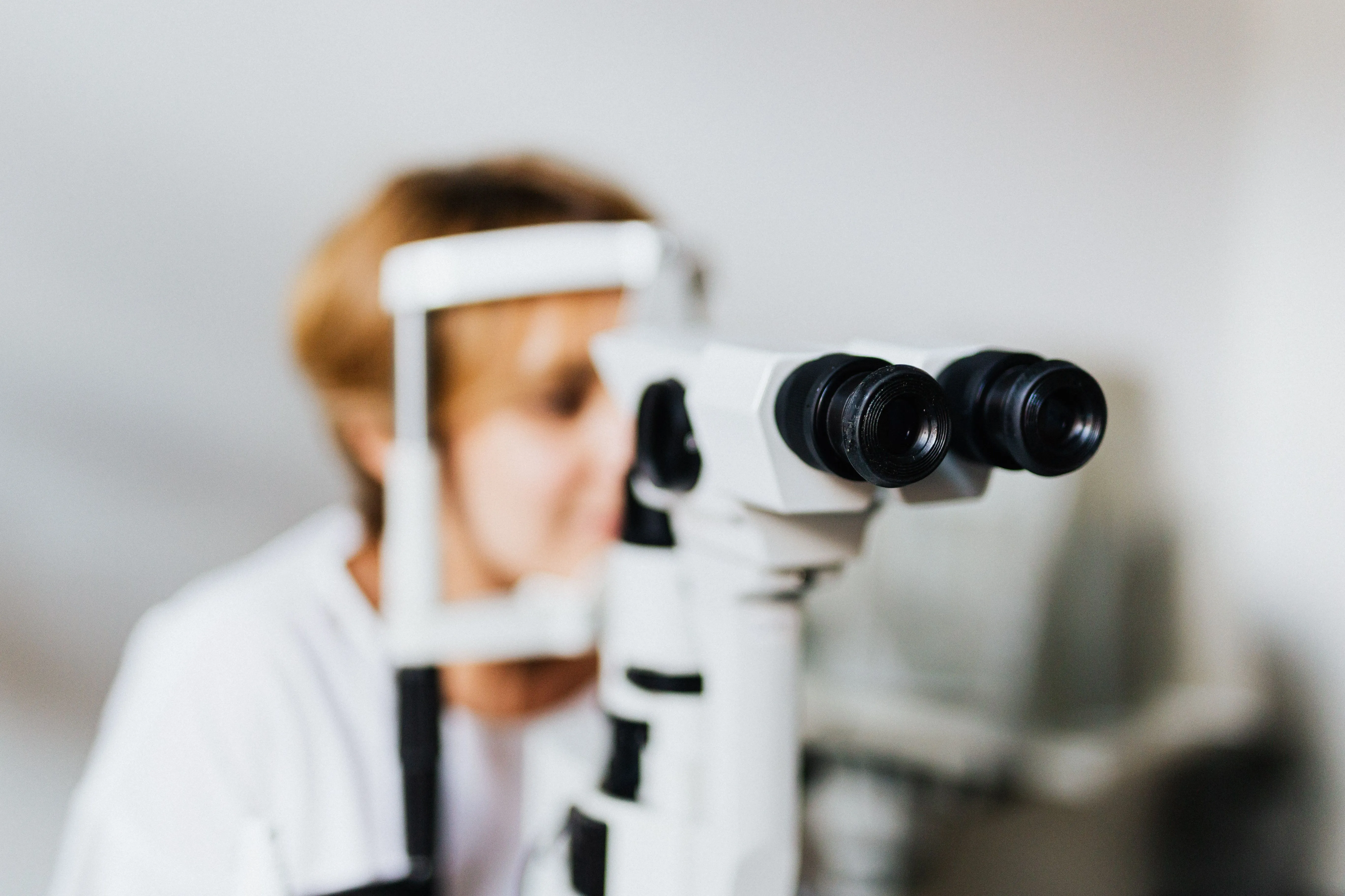 A woman is experiencing an eye examination.
